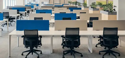 Modern open-plan office space featuring clean workstations, ergonomic chairs, and sanitized carpets provided by professional office cleaning services in El Paso, TX.